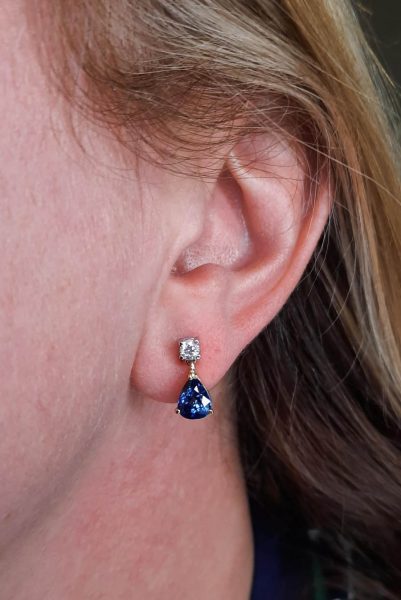 Pear Cut Sapphire and Diamond Drop Earrings; 3.20cts pear-shaped sapphires claw set in yellow gold, suspended from round brilliant-cut diamonds claw set in white gold