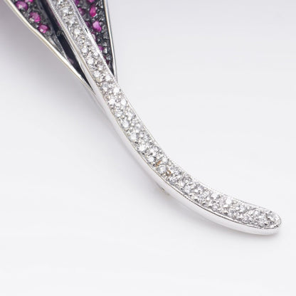 Vintage leaf-shaped brooch with rubies and diamonds in white gold.