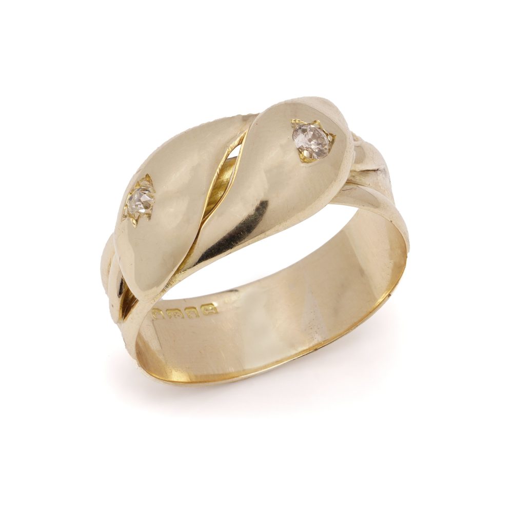 Antique gold men's snake ring set with two diamonds.
