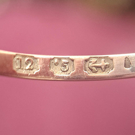 A sweet ruby and pearl cluster ring in 12ct rose gold, this ring has a three square cut rubies set vertically with half pearls leading down each shoulder.