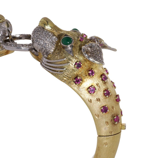 Larry dragon head gold bangle with diamonds, emeralds, and rubies.