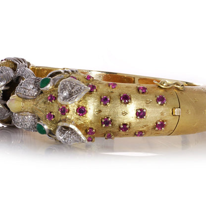 Larry dragon head gold bangle with diamonds, emeralds, and rubies.
