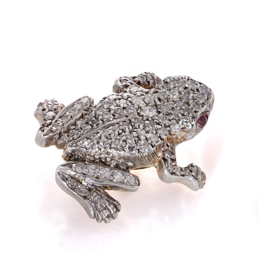 An Edwardian frog brooch in gold and silver set with diamonds and rubies.