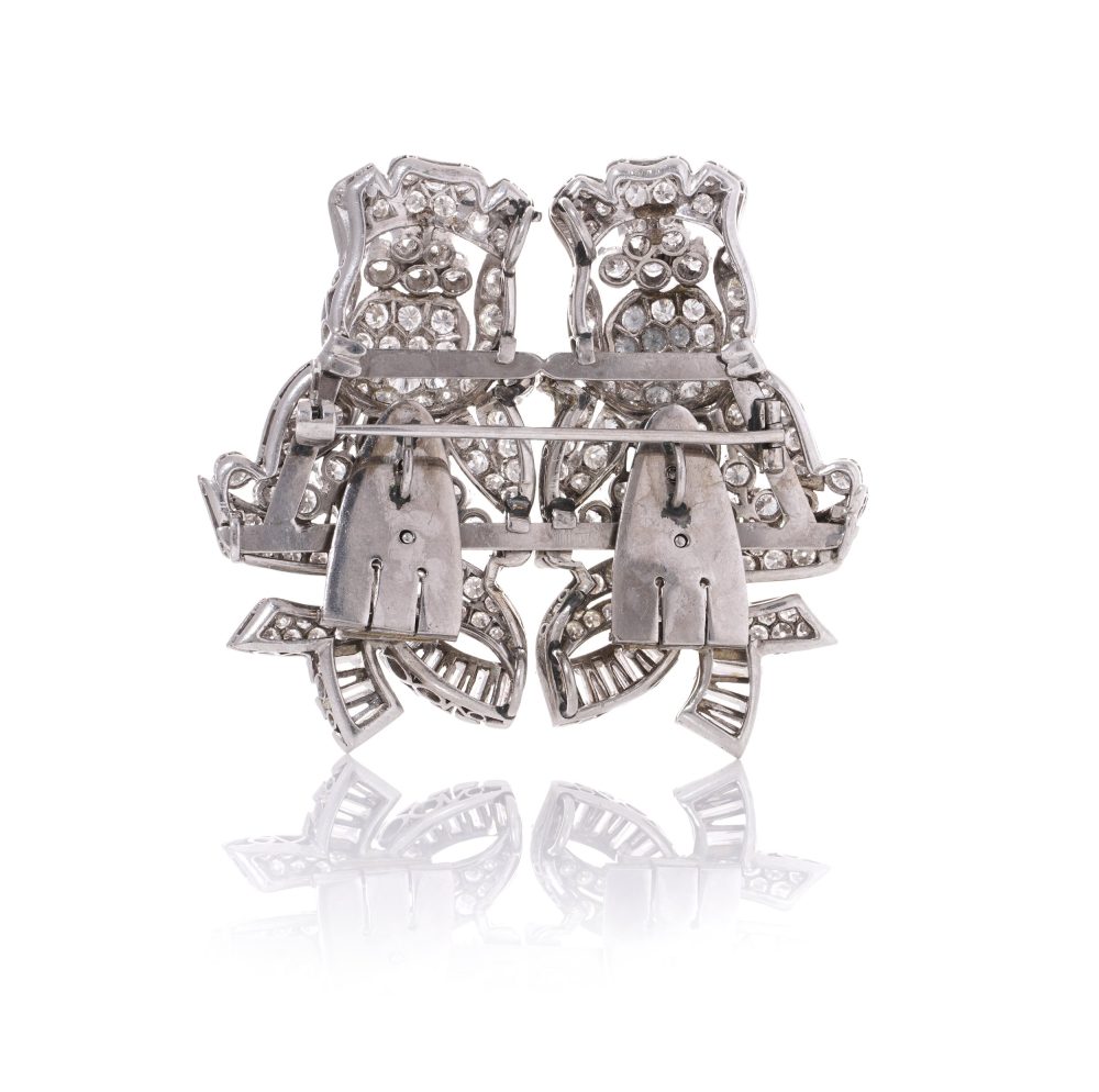 Diamond, platinum and gold double-clip/pendant flower-shaped brooch.