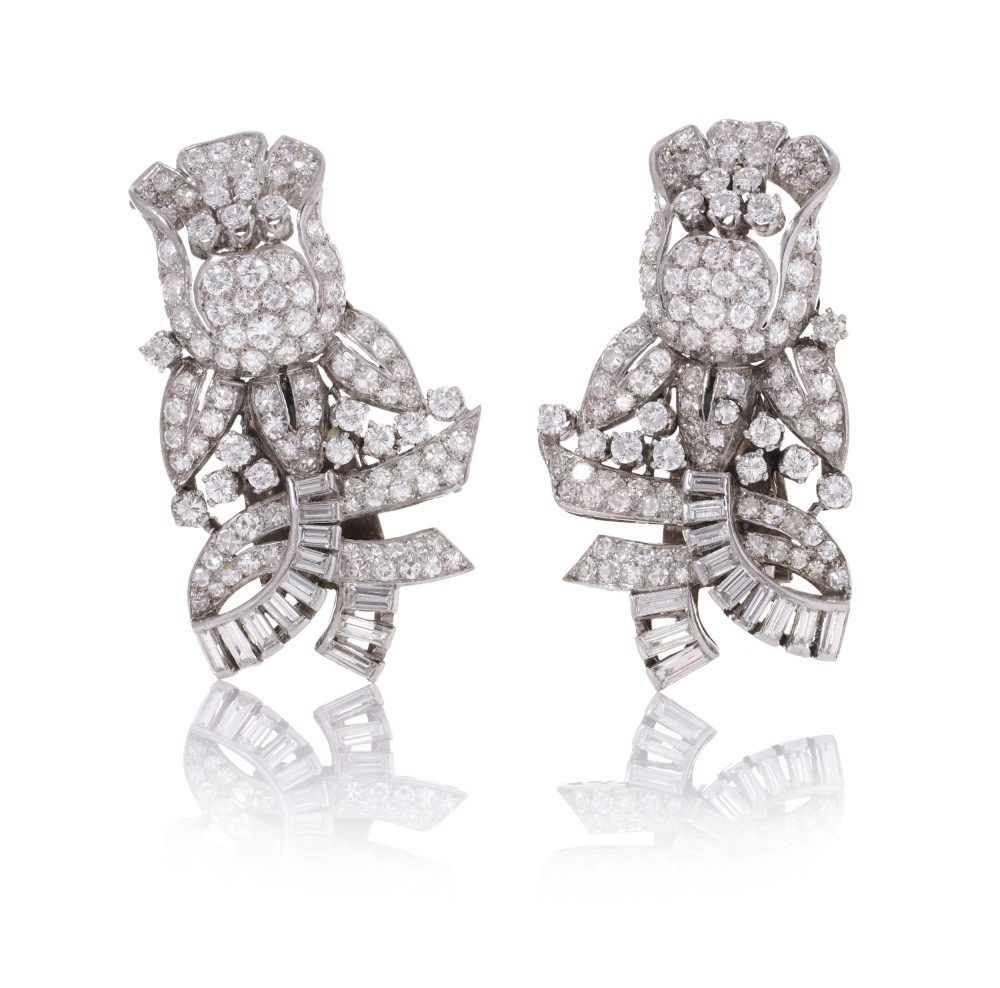 Diamond, platinum and gold double-clip/pendant flower-shaped brooch.