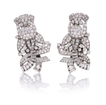 Diamond, platinum and gold double-clip/pendant flower-shaped brooch.