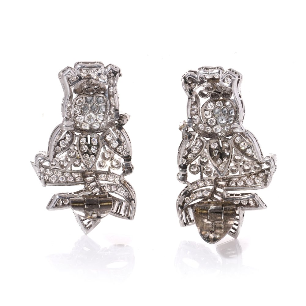 Diamond, platinum and gold double-clip/pendant flower-shaped brooch.