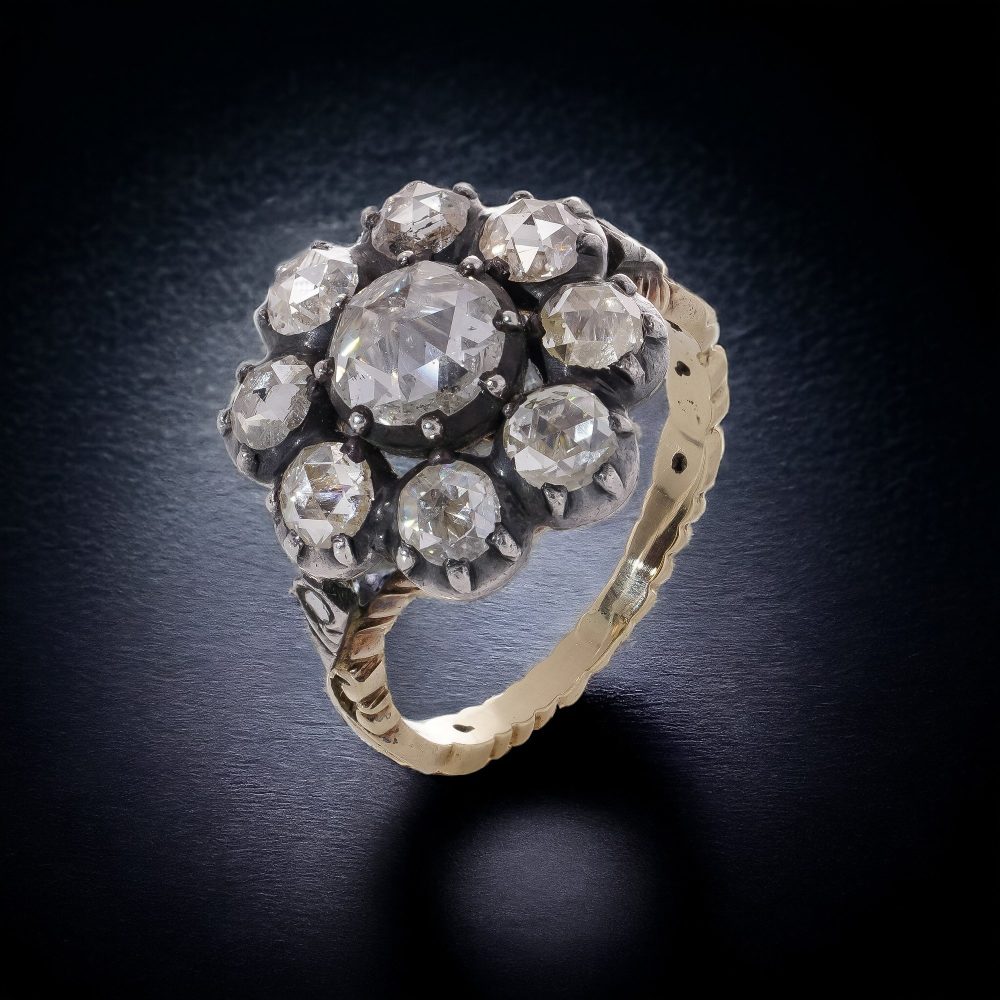 Diamond daisy cluster ring in gold and silver.