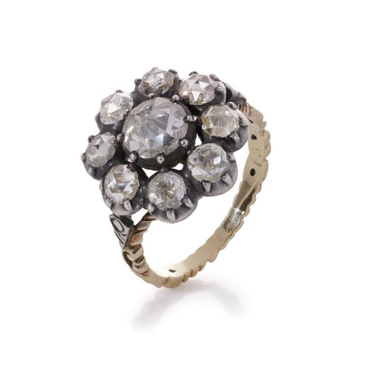 Diamond daisy cluster ring in gold and silver.