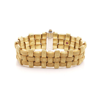 Woven design bracelet in white and yellow gold with diamonds and ruby,