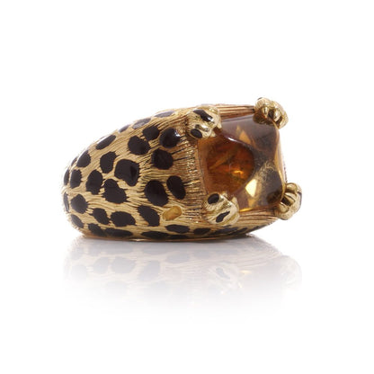 Dior cocktail ring with a sugarloaf cabochon-cut citrine, held by paw prongs in gold with black enamel leopard spots.
