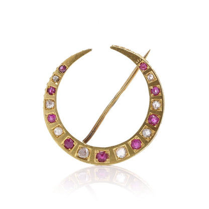 Victorian diamond and ruby crescent brooch in gold.