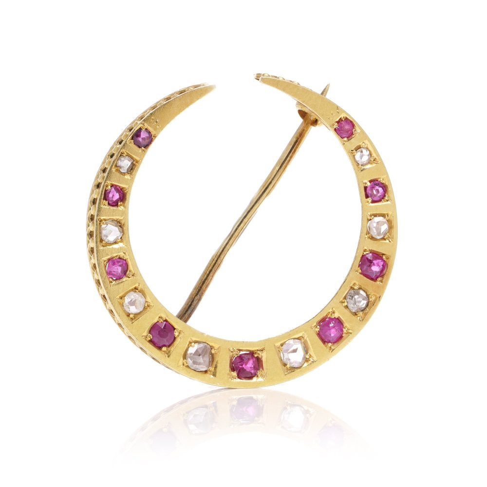 Victorian diamond and ruby crescent brooch in gold.