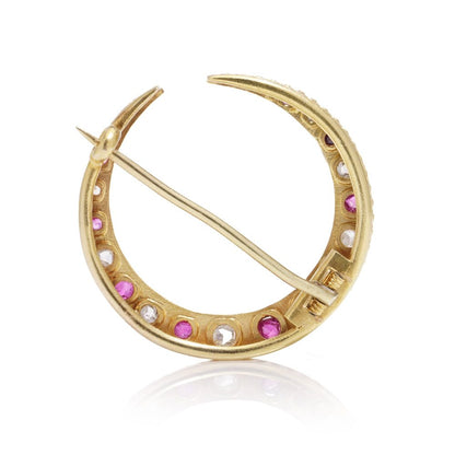 Victorian diamond and ruby crescent brooch in gold.