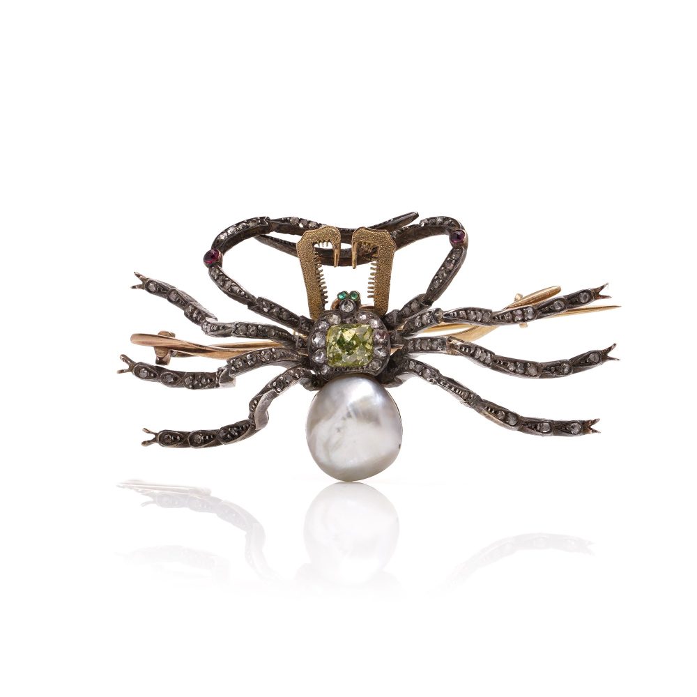 Antique spider brooch with diamonds, pearl, rubies and emeralds in gold and silver.