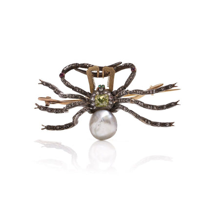 Antique spider brooch with diamonds, pearl, rubies and emeralds in gold and silver.