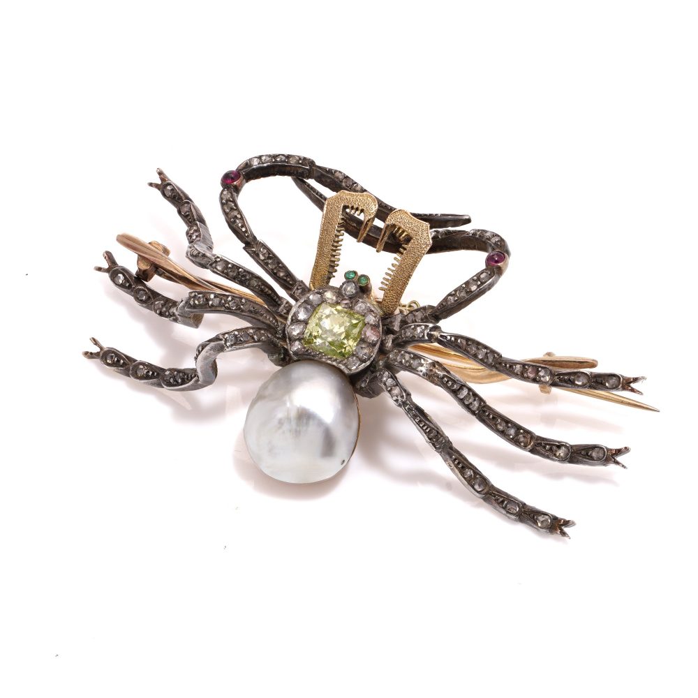 Antique spider brooch with diamonds, pearl, rubies and emeralds in gold and silver.
