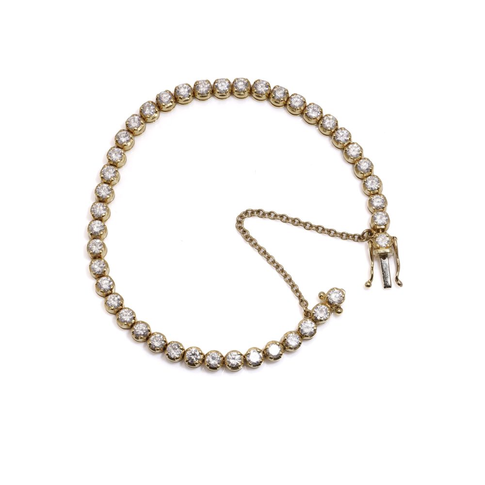 Gold tennis bracelet set with 6.30 carats of diamonds.