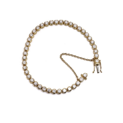Gold tennis bracelet set with 6.30 carats of diamonds.