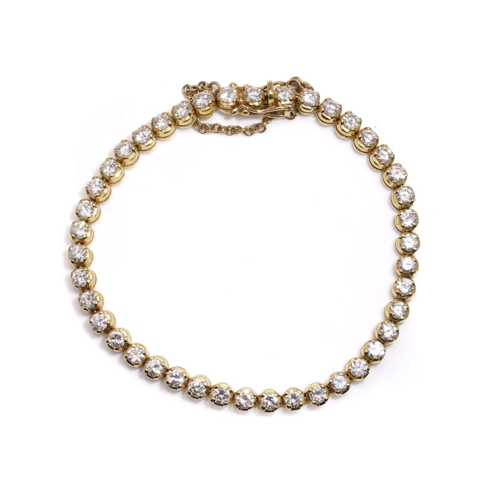 Gold tennis bracelet set with 6.30 carats of diamonds.