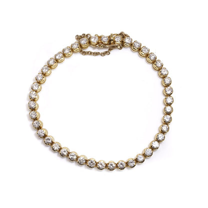 Gold tennis bracelet set with 6.30 carats of diamonds.