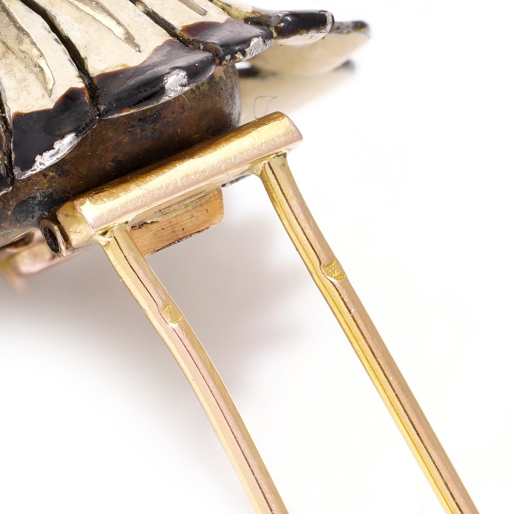 Cartier brooch in gold, silver and enamel set with gem.