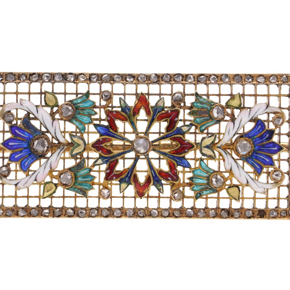 Lingerie pin brooch in gold with enamel and diamonds.