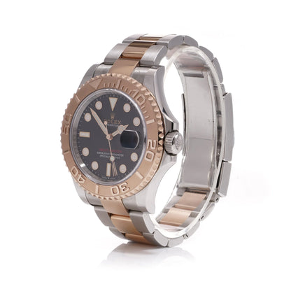 A Rolex Yacht-Master black dial wristwatch in steel and rose gold, on a white background