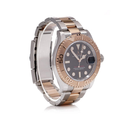 A Rolex Yacht-Master black dial wristwatch in steel and rose gold, on a white background