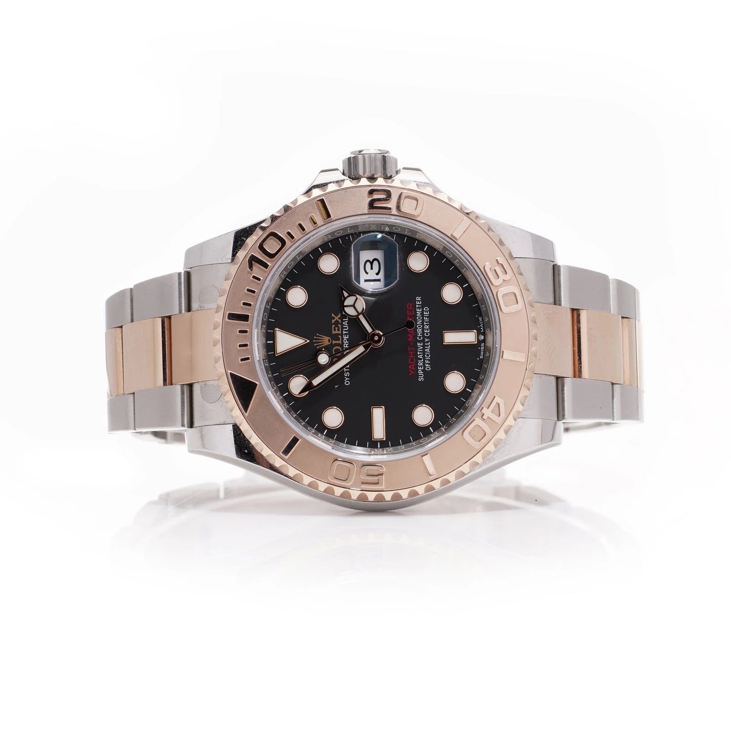 A Rolex Yacht-Master black dial wristwatch in steel and rose gold, on a white background