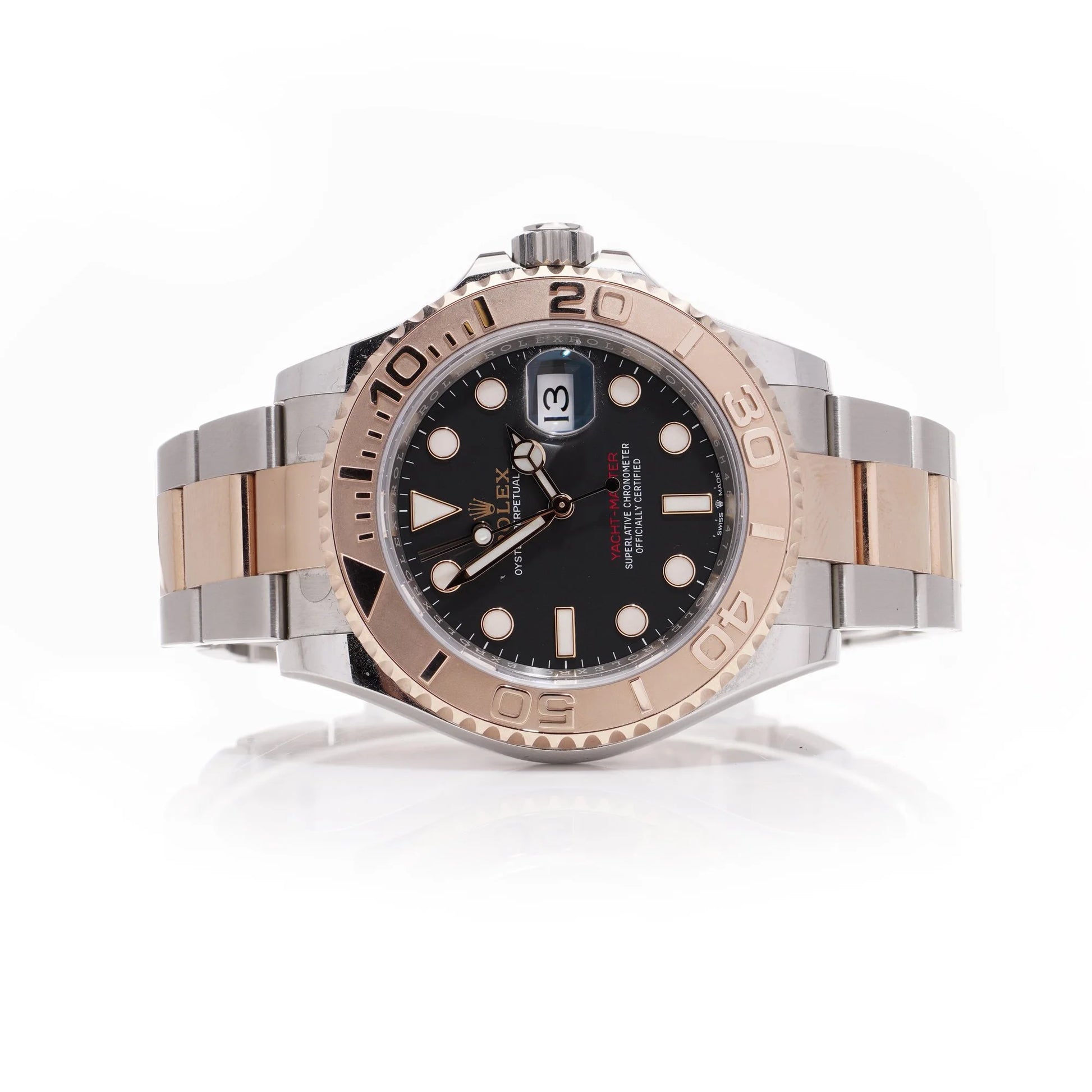 A Rolex Yacht-Master black dial wristwatch in steel and rose gold, on a white background