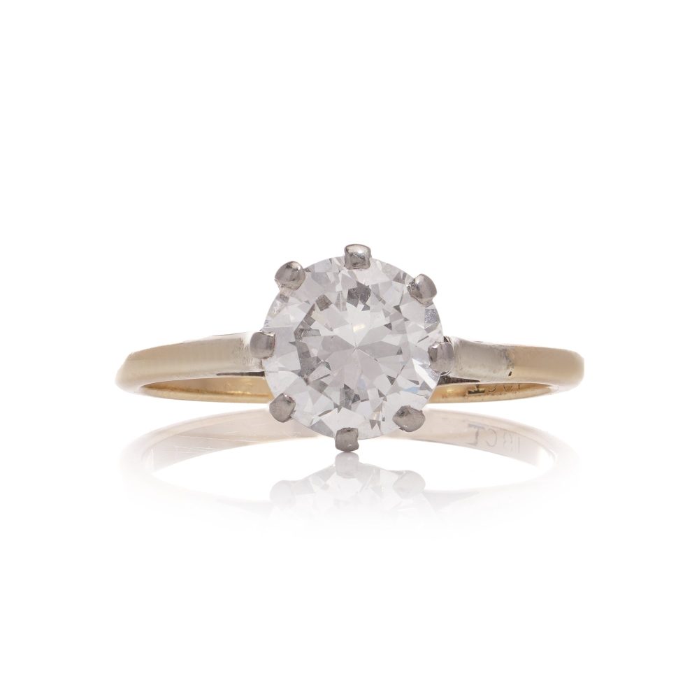 Diamond solitaire ring in gold and silver.
