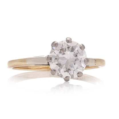 Diamond solitaire ring in gold and silver.