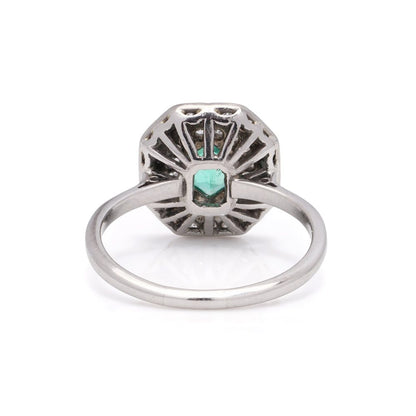 Art Deco emerald and diamond cluster ring in white gold.