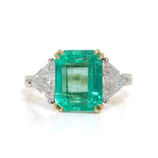 Emerald and diamond ring in gold and platinum.