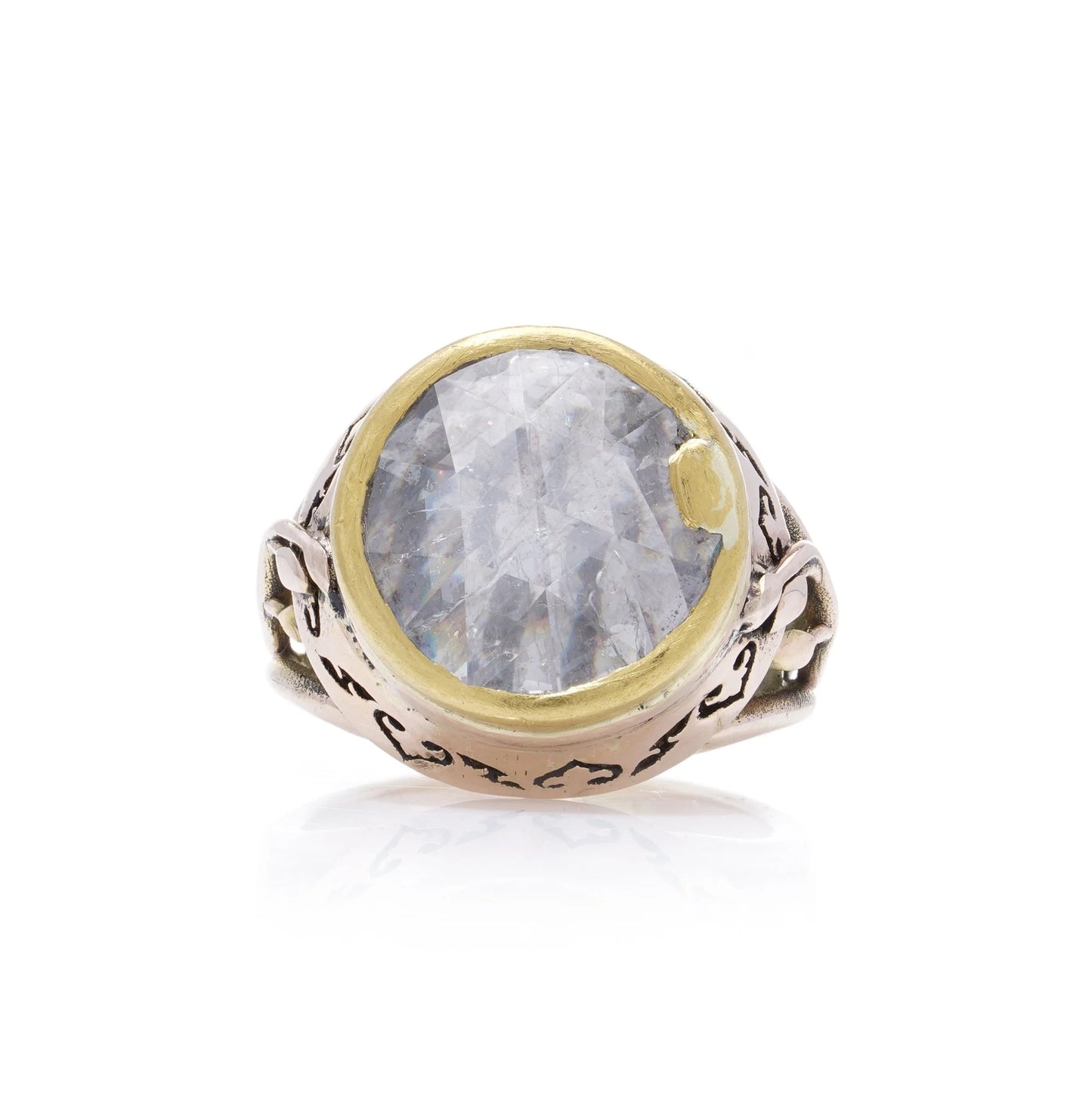 A large solitaire rose cut diamond ring in yellow and rose gold with decorative gallery and shank, on a white background