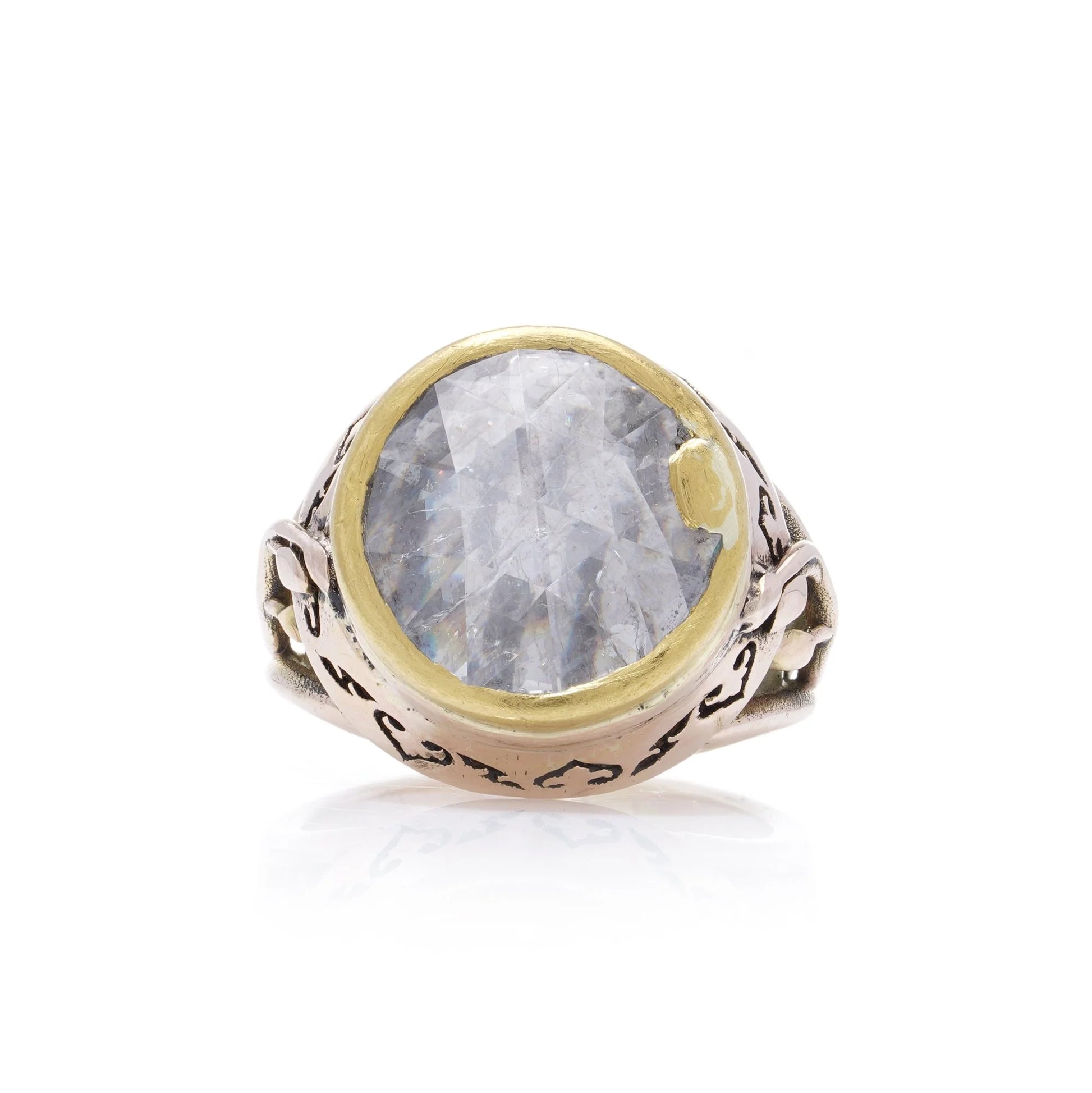 A large solitaire rose cut diamond ring in yellow and rose gold with decorative gallery and shank, on a white background
