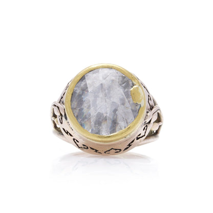 A large solitaire rose cut diamond ring in yellow and rose gold with decorative gallery and shank, on a white background