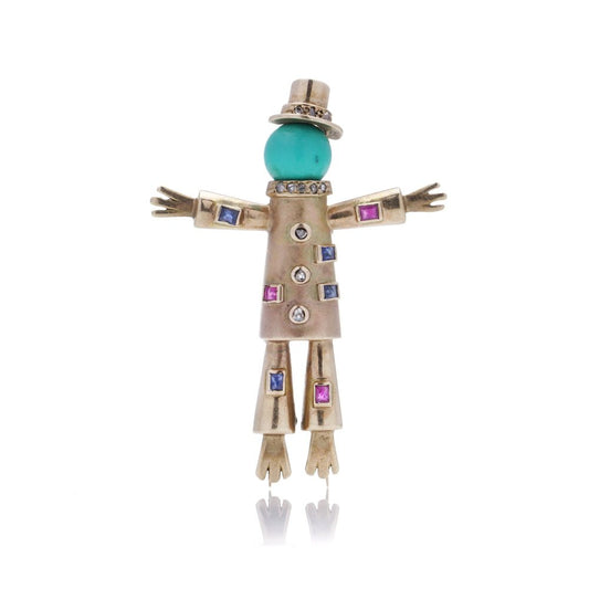 Vintage gold scarecrow brooch with gemstones.