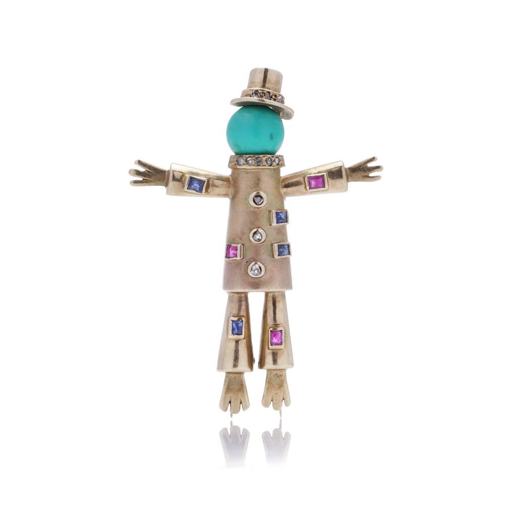 Vintage gold scarecrow brooch with gemstones.