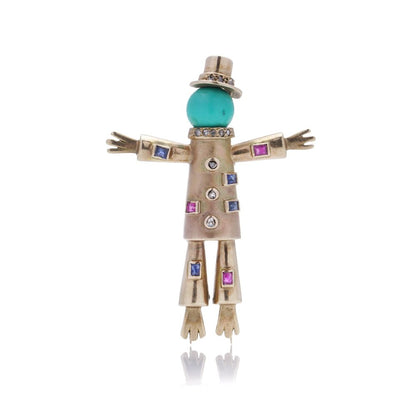 Vintage gold scarecrow brooch with gemstones.