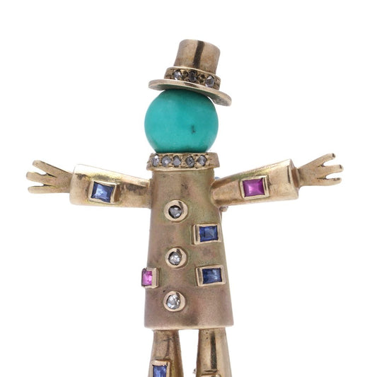 Vintage gold scarecrow brooch with gemstones.