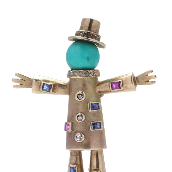 Vintage gold scarecrow brooch with gemstones.