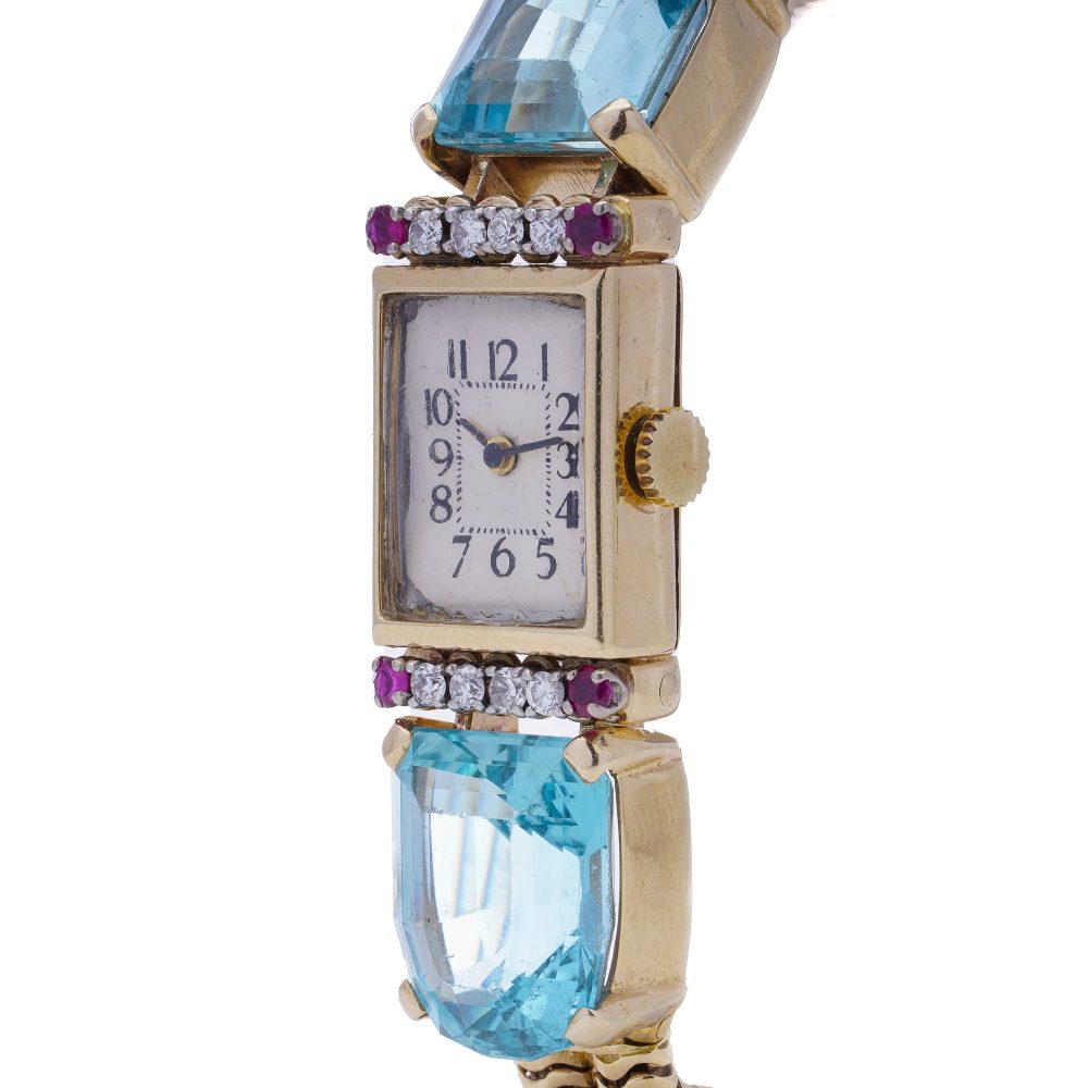 Ladies gold cocktail watch with Gemstones.