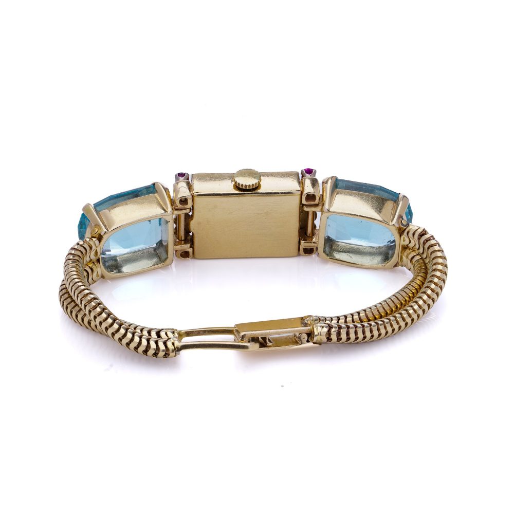 Ladies gold cocktail watch with Gemstones.