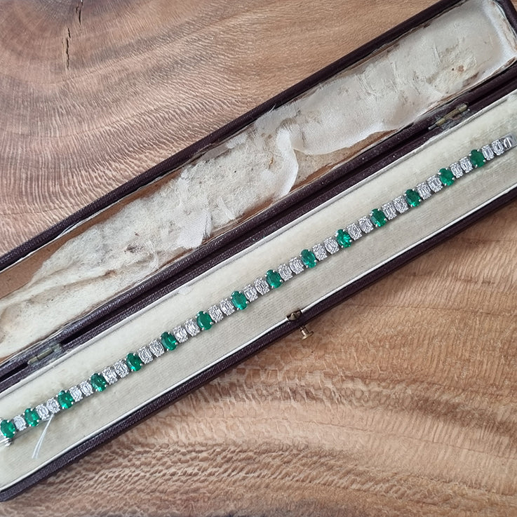Oval Cut 6.72ct Emerald and Diamond Line Tennis Bracelet in 18ct White Gold