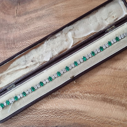 Oval Cut 6.72ct Emerald and Diamond Line Tennis Bracelet in 18ct White Gold