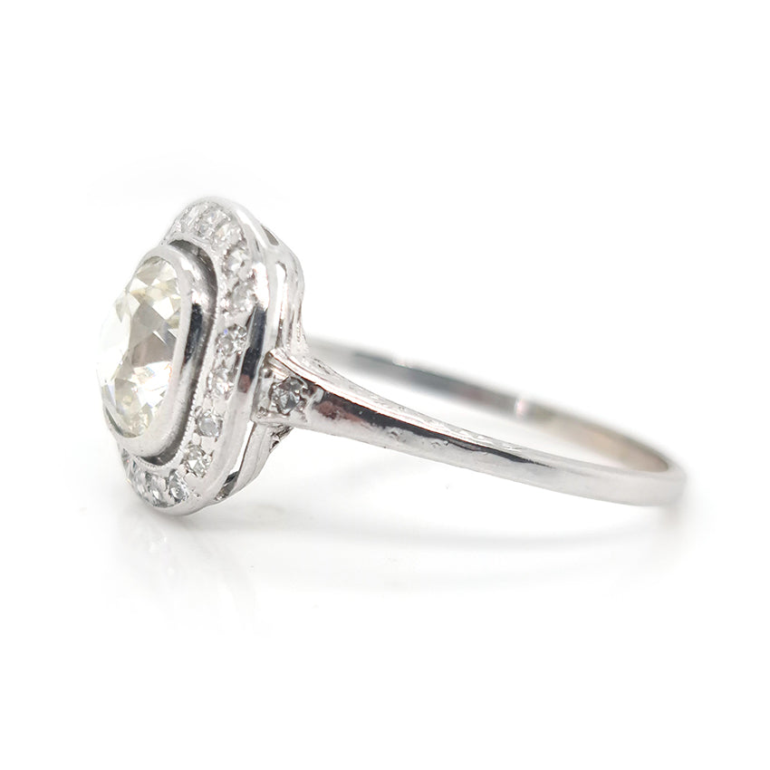 Antique 1.50ct Cushion Old Cut Diamond Halo Cluster Engagement Ring in platinum. Circa 1900s