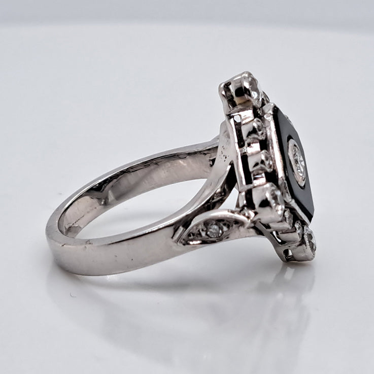 Late Art Deco Onyx and Diamond Cluster Ring in platinum and white gold. Circa 1930s