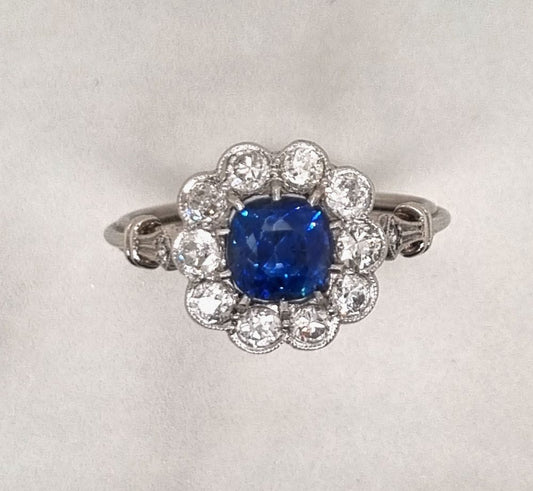 Art-Deco style sapphire and diamond cluster engagement ring in platinum
